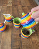 Small 2 cup rainbow teapot being poured